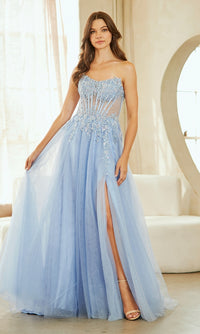 Woman wearing a light blue evening gown with a slit in a bright room.