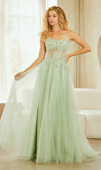 Woman wearing a light green strapless gown with intricate detailing indoors.