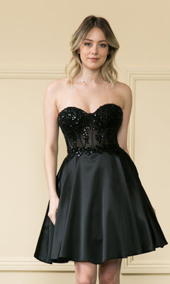 A woman wears the Corset-Style Strapless Short Homecoming Dress 9084, featuring a sequined bodice and flared satin skirt, while standing in front of a beige wall with decorative molding.