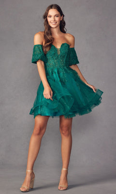 A woman wears the Bell-Sleeve Short Sweetheart Prom Dress 909, featuring a short off-the-shoulder design with corset bodice, lace and tulle details, as she stands against a gray background and smiles.