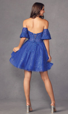 A woman wearing the Bell-Sleeve Short Sweetheart Prom Dress 909, featuring sparkly blue fabric and an off-the-shoulder design with a lace-up corset bodice, stands facing away in clear high heels.