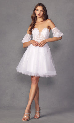A woman in the Bell-Sleeve Short Sweetheart Prom Dress 909, a white off-the-shoulder lace mini with sheer flutter sleeves and a corset bodice, stands in silver heels against a plain gray background.
