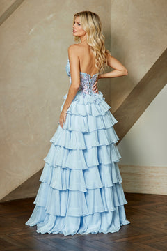 A woman wearing the Long Prom Dress: Amelia Couture 9103, a light blue, strapless gown with a beaded corset bodice and a tiered, ruffled chiffon skirt.