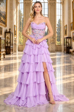 The Amelia Couture 9103 long prom dress features a lavender strapless sweetheart gown with a beaded corset bodice, a tiered ruffled skirt, and a high leg slit.