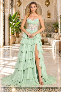 Amelia Couture 9103 sage green strapless prom dress with a beaded corset bodice featuring floral embroidery and a tiered, ruffled chiffon skirt with a high leg slit.
