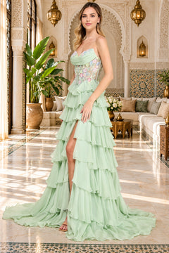 Amelia Couture 9103, a woman in a light green ruffled chiffon prom dress with a strapless sweetheart neckline, floral embroidery on the bodice, and a high slit.