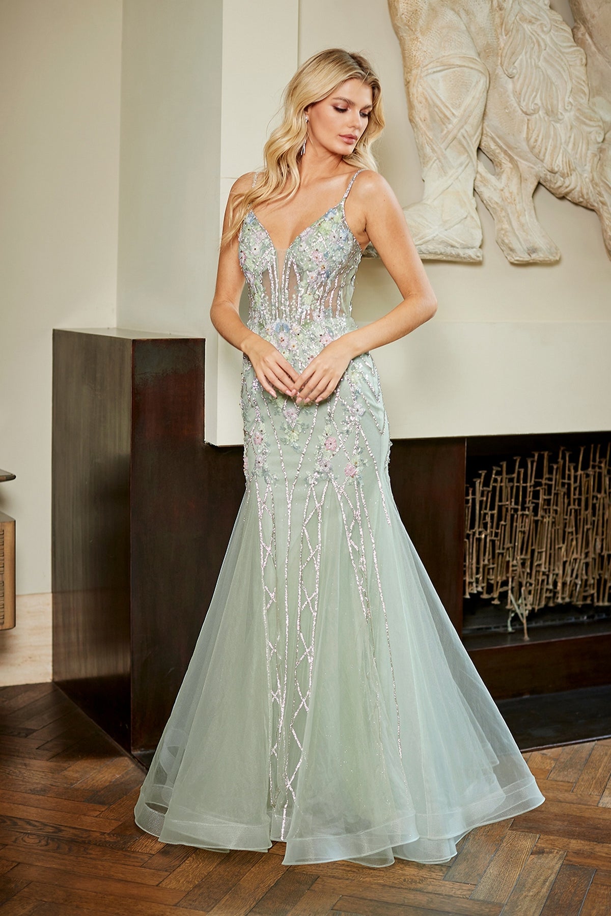 The Amelia Couture 9104 mermaid prom dress in sage green features a V-neckline, floral embroidery, and silver sequined lattice patterns.