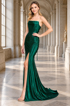 Amelia Couture 9106 strapless emerald green gown featuring a corset-style bodice, pearl embellishments, and a high side slit.