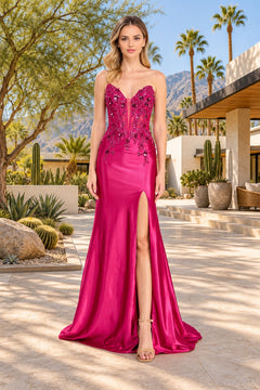 The Amelia Couture 9107 long prom dress is a strapless, magenta floor-length gown featuring a sweetheart bodice with sequin appliques and a high leg slit.