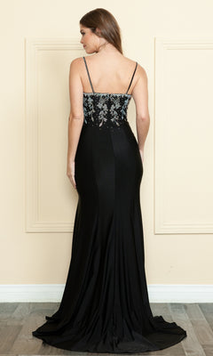 A woman wears the Beaded-Bodice Long Prom Dress (Poly USA 9122), featuring a beaded bodice and thin straps, photographed from the back indoors against a beige wall with decorative molding.