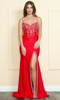 A woman poses against a beige wall wearing the Beaded-Bodice Long Prom Dress: Poly USA 9122—a red evening gown with silver embellishments, a beaded bodice, and a high front slit—her hands resting in front of her.