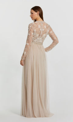 A woman models the Long Sleeve Vanilla Formal Gown: Mac Duggal 9132, featuring a beige sheer embroidered lace top and sleeves, shown from the back against a plain white background.