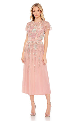 A woman models the Knee Length Wedding Guest Dress 9134 by Mac Duggal, a light pink floral beaded dress with sheer short sleeves, paired with silver high-heeled sandals against a plain white background.