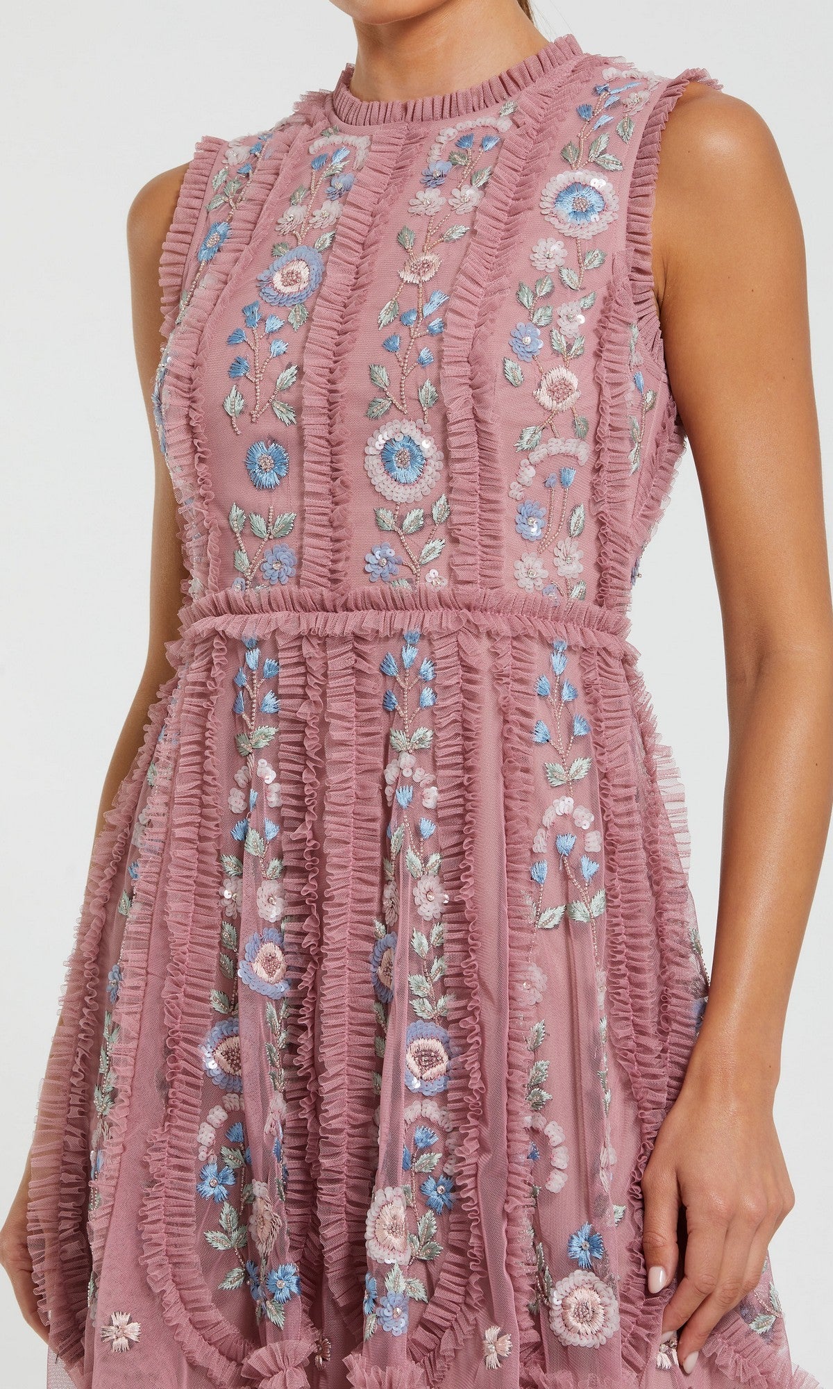 The Mac Duggal 9135 Embroidered Short Party Dress features a sleeveless mauve design with ruffle trim and blue, white, and pink floral embroidery, shown on the model from shoulders to knee—a chic party look.