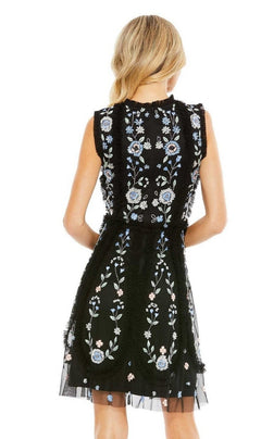 A blonde woman wears the Embroidered Short Party Dress: Mac Duggal 9135—a sleeveless black cocktail dress with blue and white floral embroidery—shown from the back.