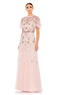 A woman models the Long Formal Dress 9136 by Mac Duggal, a floor-length pale pink A-line gown with beading, floral embroidery, sheer sweetheart neckline, and short sleeves, standing against a plain white background.