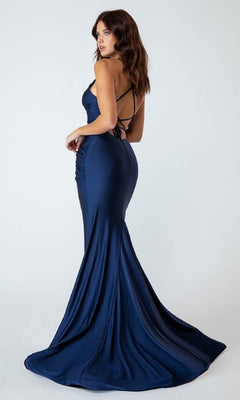 Woman wearing the Classic Long Mermaid Prom Dress: Eureka 9151, a navy blue, floor-length gown with thin straps and open back, stands against a plain light background and looks over her shoulder.