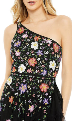 A woman wears the Mac Duggal 9164, a one-shoulder floral formal dress with multicolored embroidery—an elegant choice for special occasions.