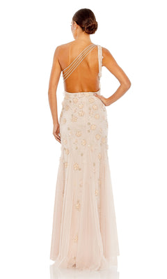 A woman stands with her back to the camera in the elegant Mac Duggal Long Formal Dress 9168, a floor-length, light pink one-shoulder gown featuring floral embellishments, a low back with three thin straps, and an A-line silhouette.