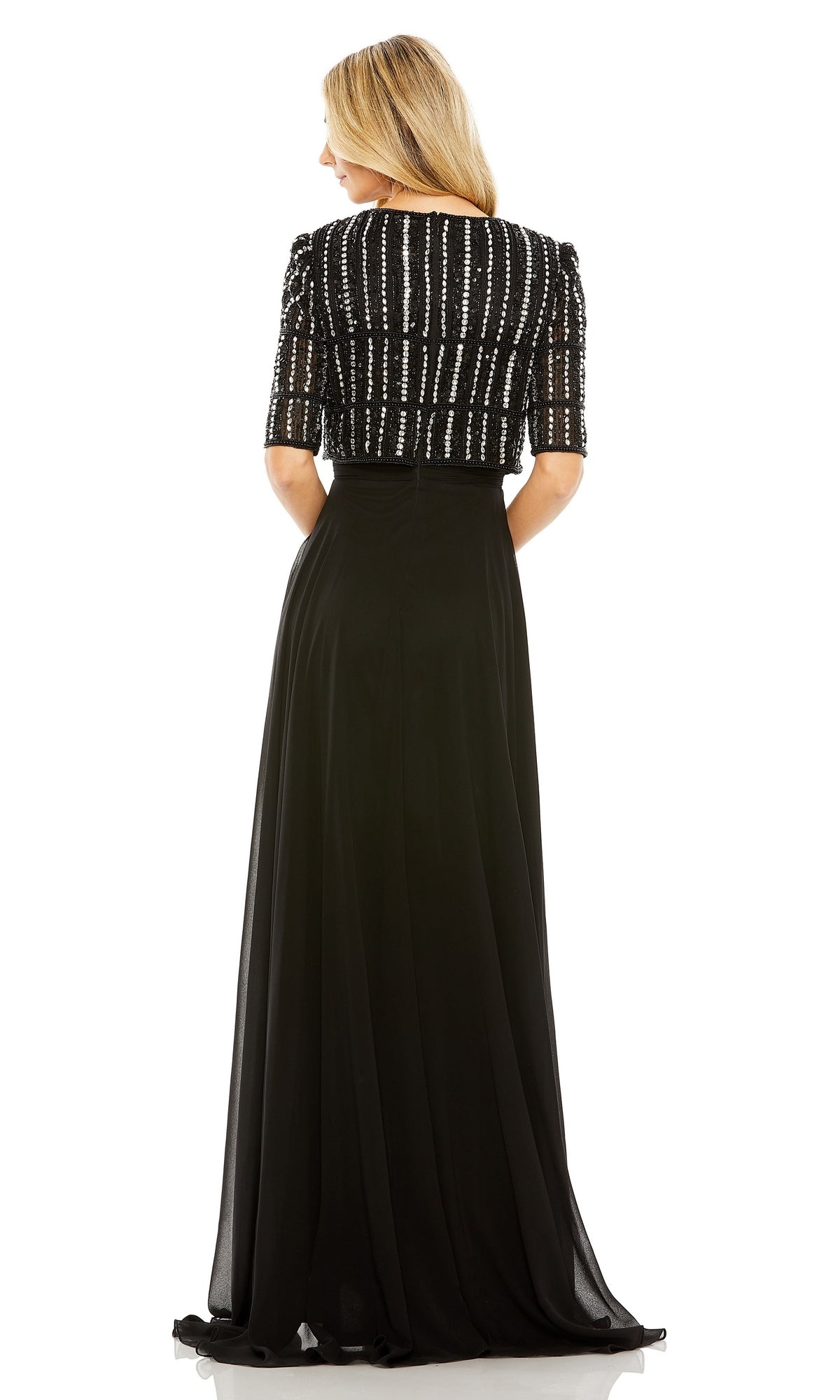 A woman is shown from the back in the Mac Duggal 9180 Short Sleeve Long Formal Dress, featuring an A-line silhouette and a beaded top, standing against a plain white background.