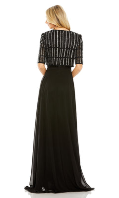 A woman is shown from the back in the Mac Duggal 9180 Short Sleeve Long Formal Dress, featuring an A-line silhouette and a beaded top, standing against a plain white background.