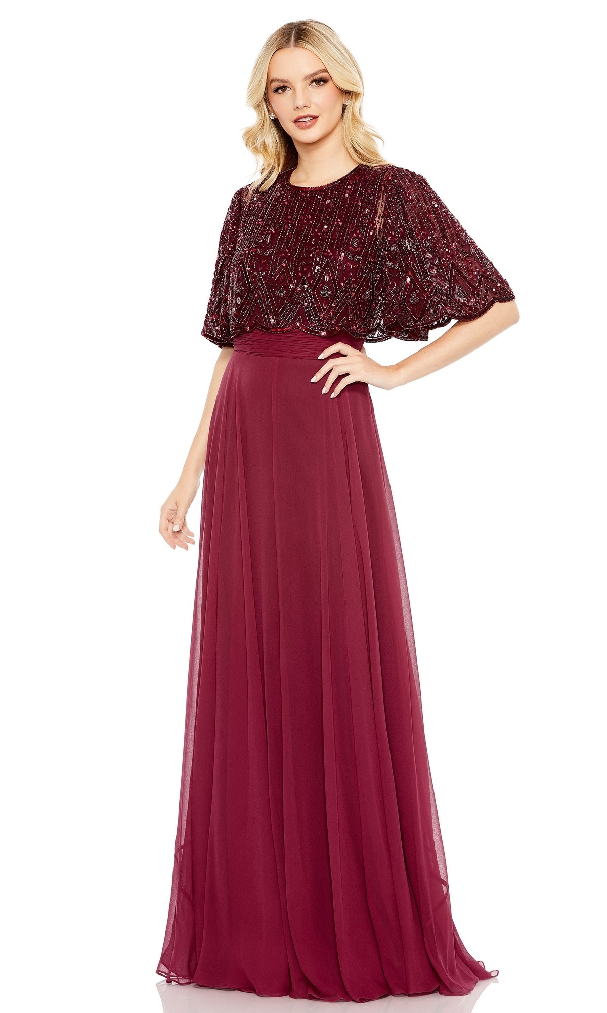 Woman wearing the Mac Duggal 9181 Cape Sleeve Long Formal Dress, featuring a beaded bodice, cape sleeves, and a flowing chiffon skirt in burgundy, standing against a white background.