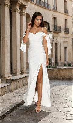 Woman wearing the Shoulder-Ties Long Jersey Prom Dress (Eureka 9181) with off-the-shoulder bow details and a thigh-high slit stands against a plain light background.