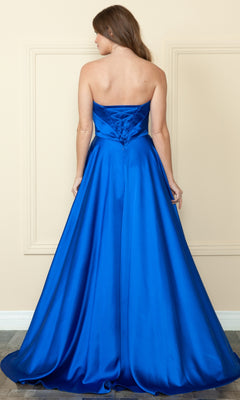 A woman stands with her back to the camera against a beige wall, wearing a royal blue Strapless Long A-Line Prom Dress with Pockets and lace-up back.