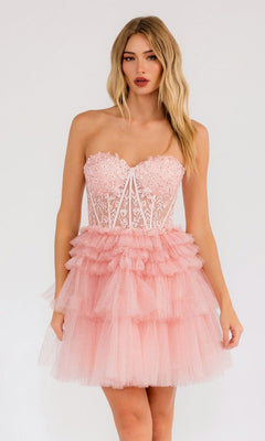 A woman models the Juliet JT918S Embroidered Glitter Homecoming Dress with a strapless sweetheart neckline, lace bodice, and tiered tulle skirt in light pink, standing against a plain white background.