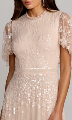 A woman wearing the Mac Duggal 9192 short-sleeve blue formal dress stands against a plain background.