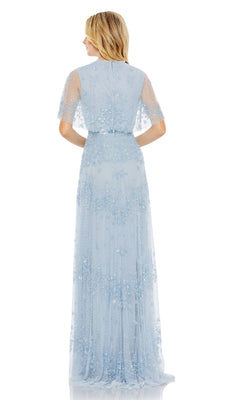 A woman faces away, wearing the Mac Duggal 9192 short-sleeve blue formal dress featuring floral embellishments and a floor-length design.