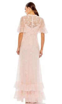 Woman wearing the Mac Duggal 9199 Short Sleeve Beaded Formal Gown, featuring floral embroidery, sheer sleeves, and ruffle details, shown from the back.