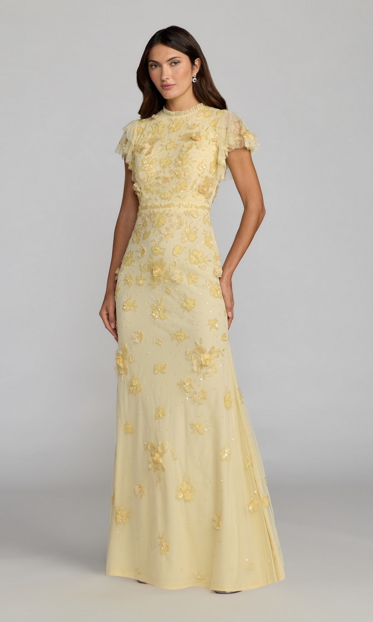 A woman stands against a plain gray background wearing the Mac Duggal 9206 Beaded Periwinkle Formal Gown.