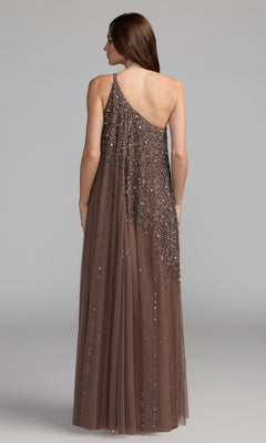 A woman faces away, wearing the Mac Duggal 9224 one-shoulder long formal dress—a floor-length brown gown with sequins and a sheer overlay—ideal for special occasions.