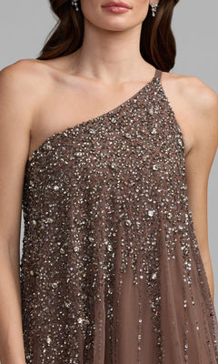A woman models the Mac Duggal 9224, a one-shoulder brown gown with silver sequins and beading, shown from shoulders to waist—an elegant choice for formal events.