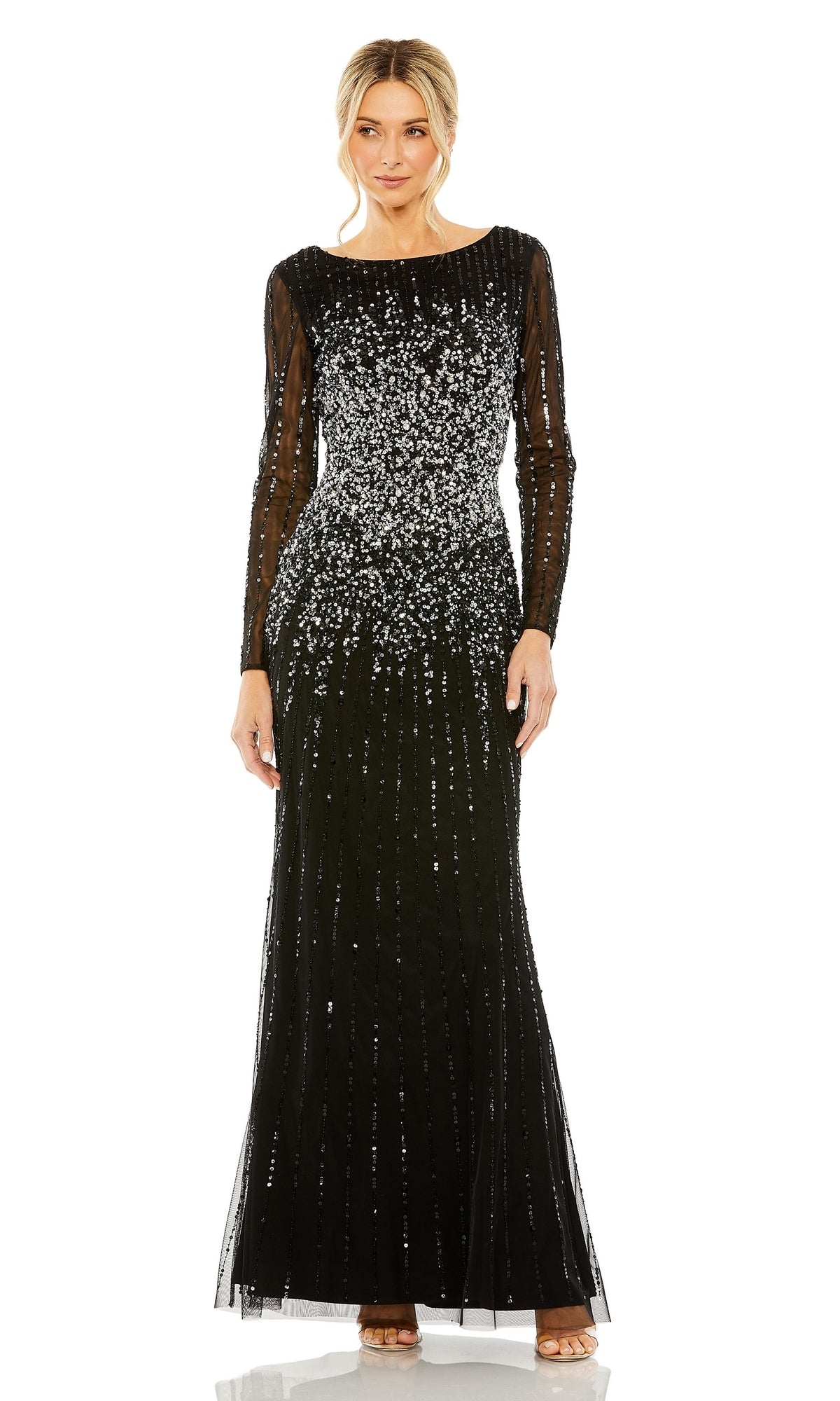 A woman models the Mac Duggal 9226—a long sleeve, floor-length black sequin formal gown—while standing against a white background.