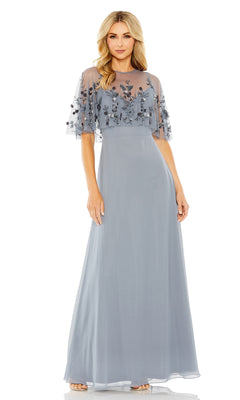 Woman in a floor-length, light blue Mac Duggal 9229 prom dress with sheer embroidered short sleeves and bodice, standing against a white background.