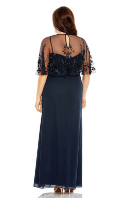 A woman faces away wearing the Mac Duggal Long Plus-Size Prom Dress 9230, a floor-length navy gown featuring a sheer embroidered capelet overlay and keyhole back detail.