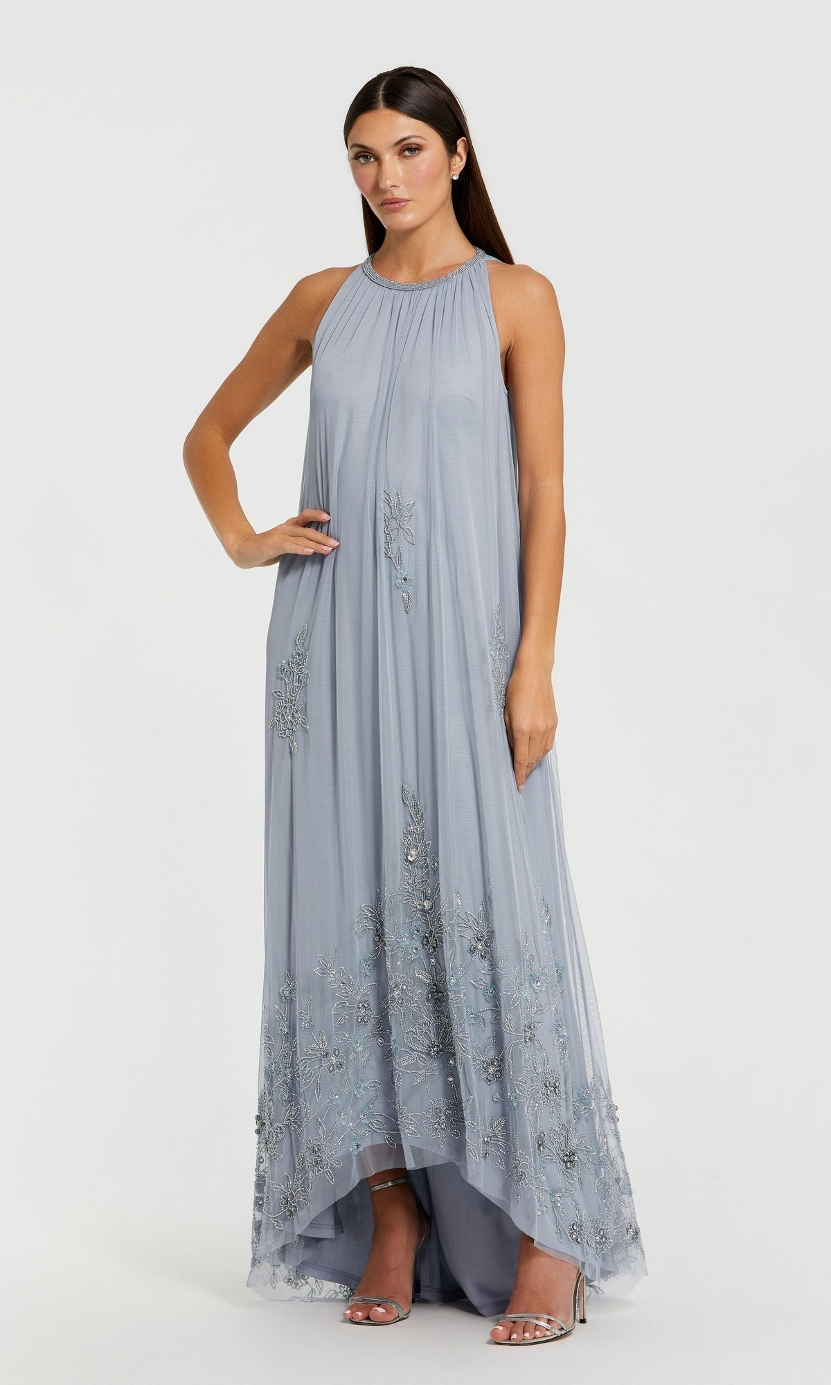 A woman wearing the Mac Duggal 9232 Nude Gold Long Trapeze Formal Dress stands against a plain white background.