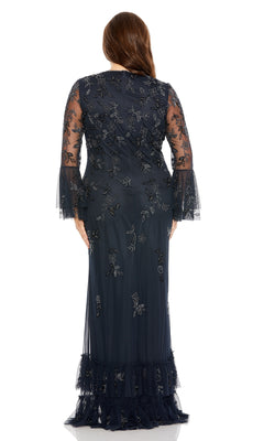 A woman stands facing away, wearing the Long Plus-Size Formal Dress 9239 by Mac Duggal in midnight blue, featuring long sleeves and delicate floral embroidery.