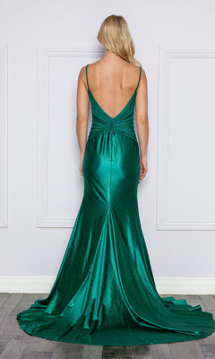 A woman in the Sheer Cut-Out Sides Long Prom Dress 9260, a floor-length emerald green mermaid gown with a low back and slight train, stands against a white wall.