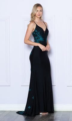 A woman poses indoors against a light wall in the Contrasting Beads Long Black Prom Dress 9274, featuring teal sequin embellishments and thin straps, exuding elegance with one hand gracefully resting on her waist.