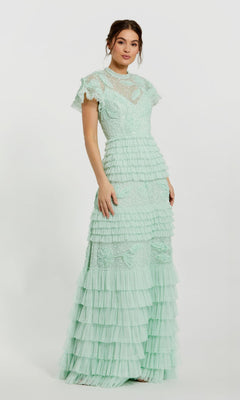 A woman models the Mac Duggal 9278 long sage green formal dress, featuring lace details and ruffled tiers, standing against a plain white background.