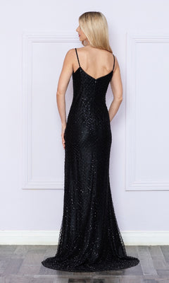 A woman with long blonde hair stands facing away, wearing the Sequin-Net Long Prom Dress with Side Slit 9288—a floor-length black dress with thin straps and a subtle shimmer—in front of a light-colored wall.