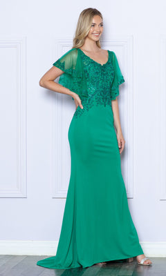 A woman stands against a light wall wearing the Flutter-Sleeve Embellished Long Formal Dress 9318, a plus-size, floor-length emerald gown featuring short sheer flutter sleeves and floral beaded details on the bodice.