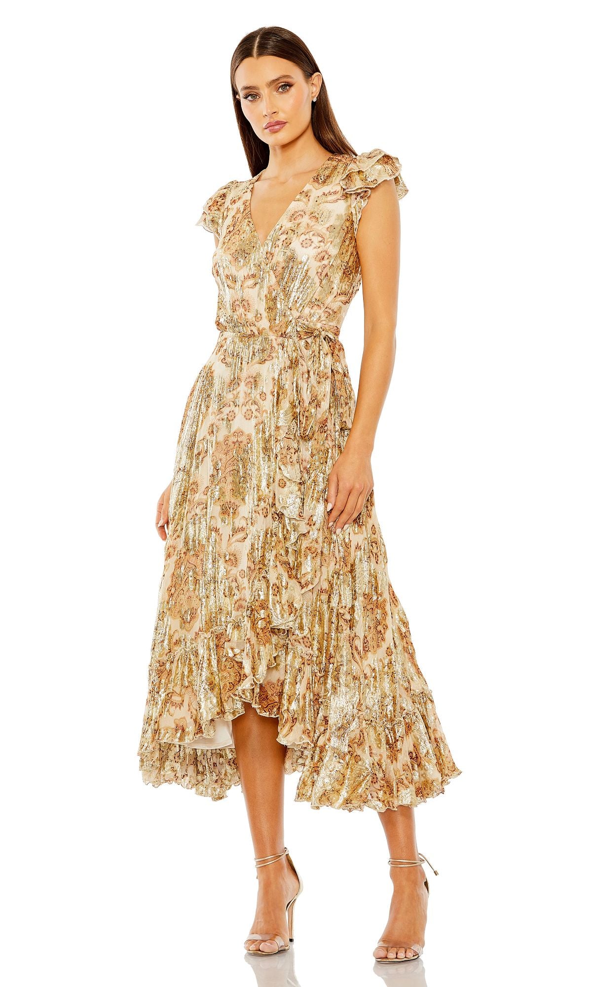 A woman wears the Mac Duggal 9319 Midi Print Wedding Guest Dress, featuring a floral print, ruffle sleeves, high-low hem, and silver high-heeled sandals.