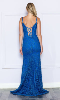 A woman models the Glitter-Lace Long Corset Prom Dress 9354, a fitted floor-length blue evening gown with thin straps and a lace-up back, standing facing a white wall.