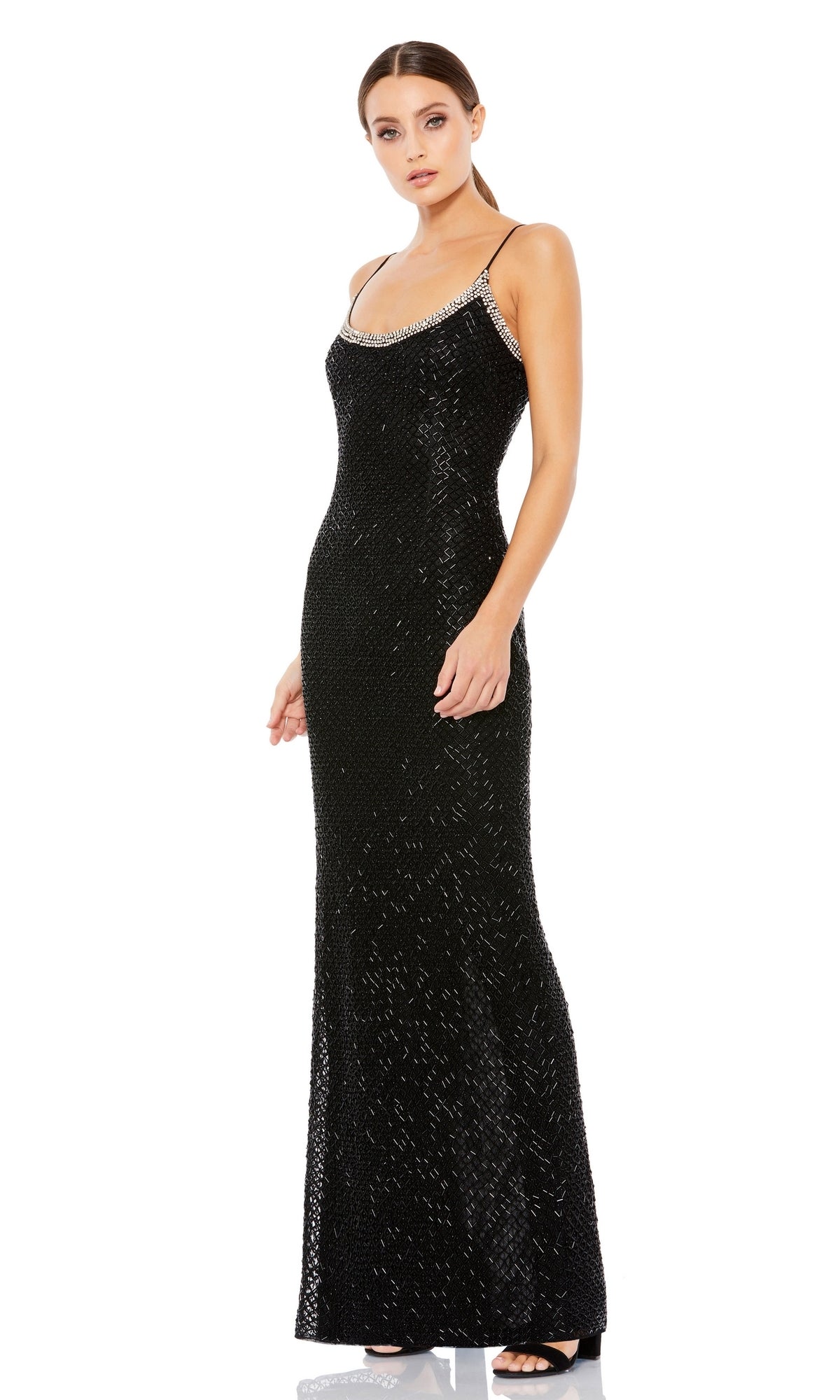 A woman wears the Mac Duggal 93551 Sleek Long Beaded Prom Dress—sleeveless, floor-length, black with sequins, thin straps, and silver beaded neckline—posed against a white background.