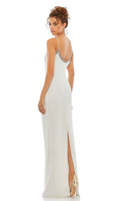 A woman in profile wears the Sleek Long Beaded Prom Dress: Mac Duggal 93551, a sleeveless, floor-length gown with silver beaded details and a thigh-high slit, turning her head toward the camera.