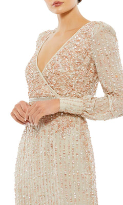 Woman wearing the Mac Duggal 93593 knee-length wedding guest dress with long sleeves, V-neck, and beige sequin and bead embellishments—a stunning semi-formal choice.